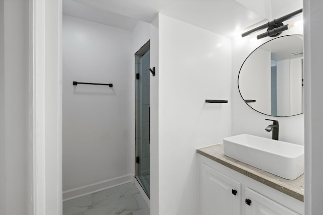 bathroom with baseboards, marble finish floor, a stall shower, and vanity