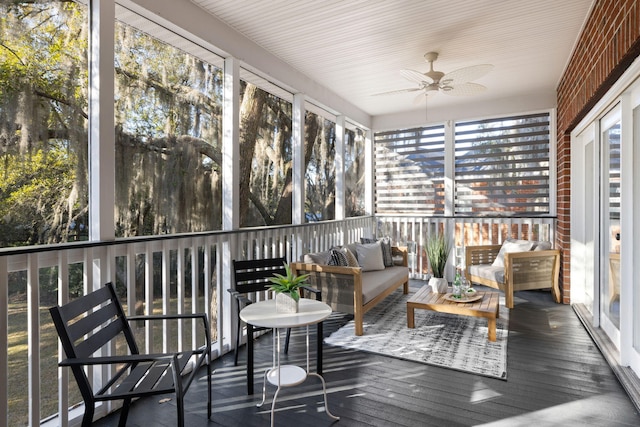 sunroom featuring ceiling fan