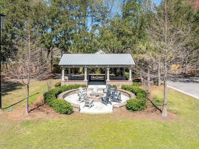 exterior space featuring a gazebo, a lawn, a fire pit, and a patio