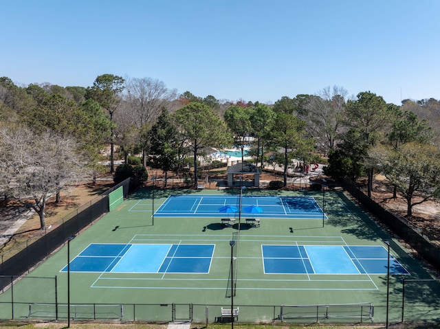 view of tennis court featuring fence