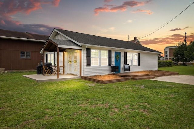 back house at dusk with a yard