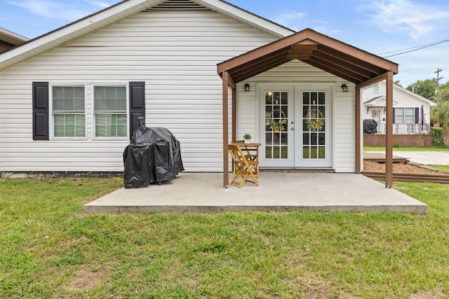 back of house with a yard, a patio, and french doors