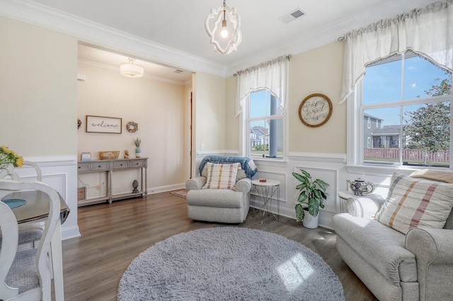 living area featuring dark wood-type flooring and ornamental molding