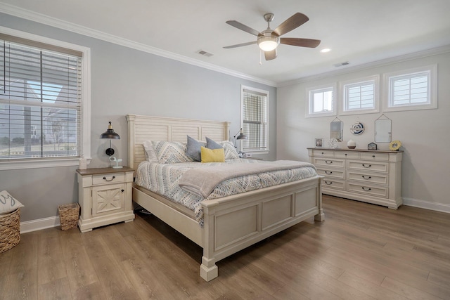 bedroom with ceiling fan, light hardwood / wood-style floors, and ornamental molding