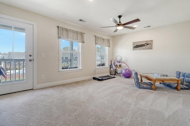 interior space featuring a wealth of natural light, carpet flooring, and ceiling fan