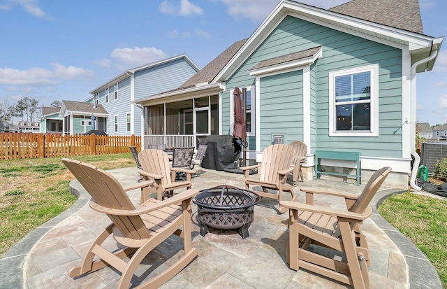 back of property with a patio and an outdoor fire pit