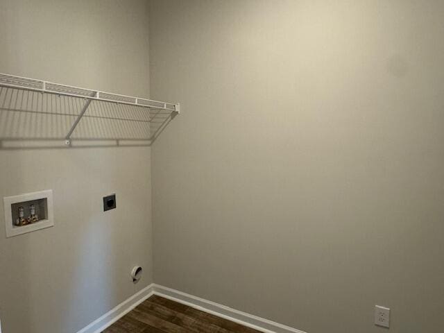 clothes washing area with washer hookup, electric dryer hookup, and dark wood-type flooring