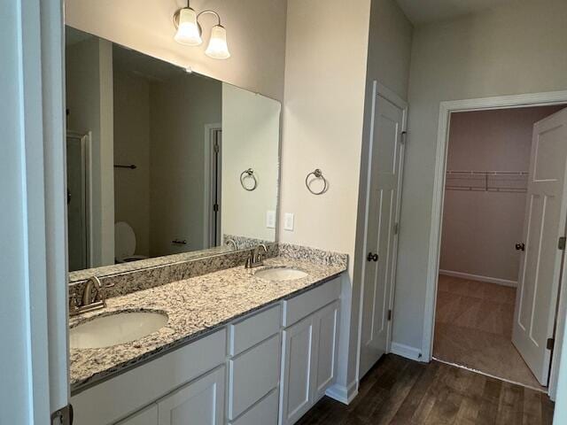 bathroom with hardwood / wood-style floors and vanity