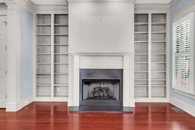 183 Ionsborough St, Mount Pleasant, SC 29464 - unfurnished living room with built in features, a fireplace with raised hearth, wood finished floors, and ornamental molding