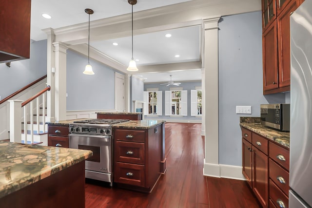 183 Ionsborough St, Mount Pleasant, SC 29464 - kitchen with appliances with stainless steel finishes, dark brown cabinets, dark wood-style flooring, ceiling fan, and dark stone counters