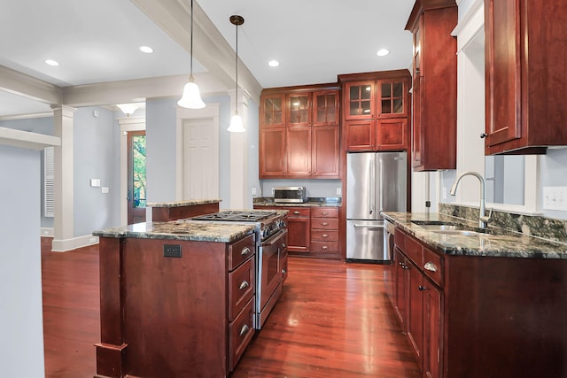 183 Ionsborough St, Mount Pleasant, SC 29464 - kitchen featuring high end appliances, dark wood finished floors, a center island, dark brown cabinets, and hanging light fixtures