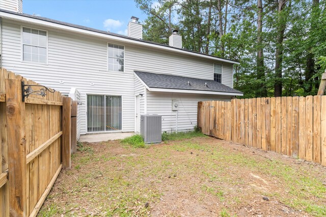 7813 Sandida Ct, North Charleston, SC 29418 - rear view of house featuring a chimney, cooling unit, and a shingled roof