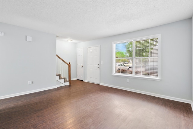 7813 Sandida Ct, North Charleston, SC 29418 - entryway featuring stairs, dark wood-style floors, a textured ceiling, and baseboards