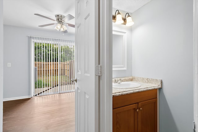 7813 Sandida Ct, North Charleston, SC 29418 - bathroom with vanity, wood finished floors, a ceiling fan, and baseboards