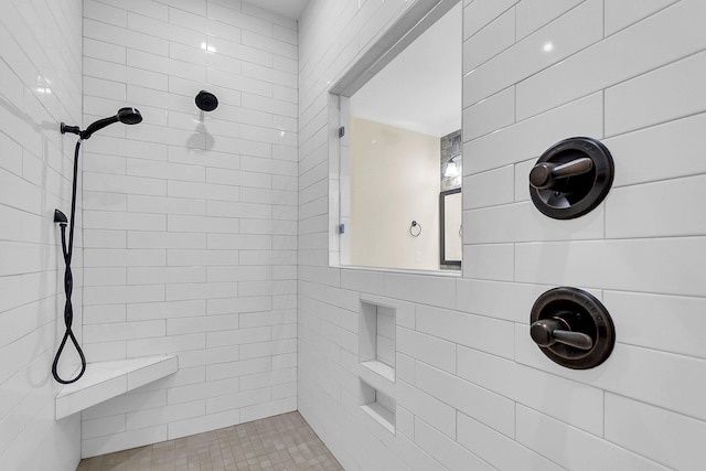 bathroom with a tile shower