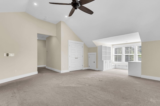 additional living space featuring lofted ceiling, light carpet, and ceiling fan