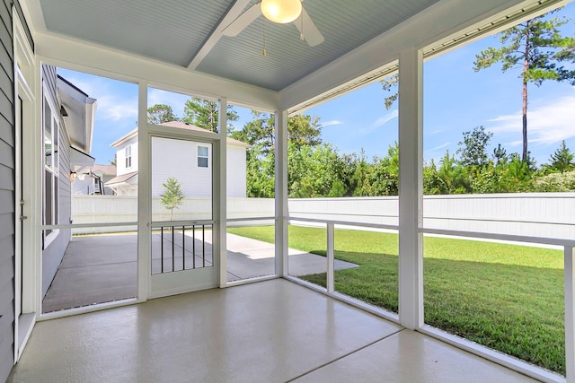 unfurnished sunroom with ceiling fan and plenty of natural light