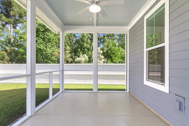 unfurnished sunroom with ceiling fan