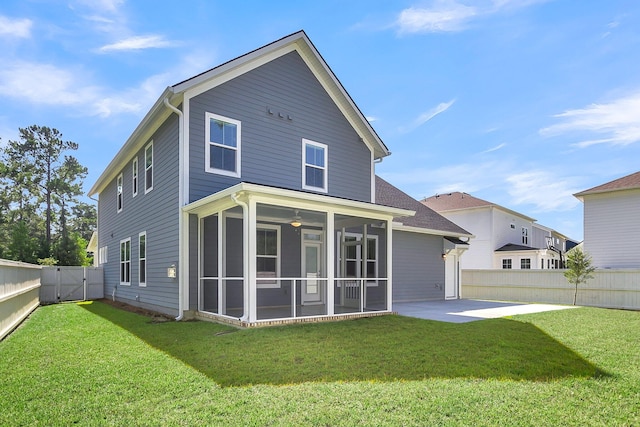 back of house featuring a sunroom, a lawn, and a patio area