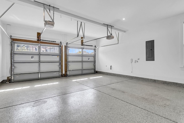 garage with a garage door opener and electric panel