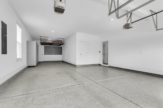 garage featuring a garage door opener and electric panel