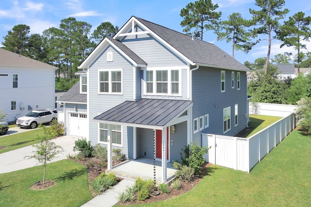 view of front facade with a garage, a front lawn, and covered porch