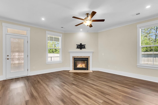 unfurnished living room with crown molding, wood-type flooring, and ceiling fan