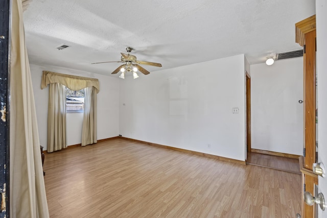 unfurnished room with a textured ceiling, ceiling fan, and light hardwood / wood-style floors