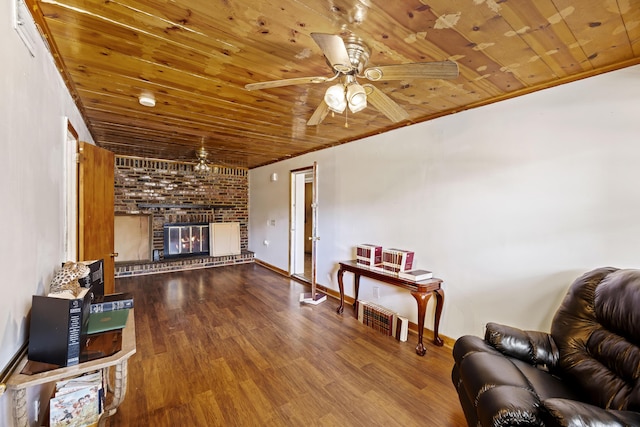 living room featuring ornamental molding, wooden ceiling, a fireplace, and hardwood / wood-style flooring