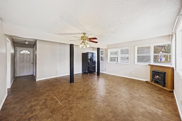 unfurnished living room with ceiling fan, cooling unit, and a textured ceiling