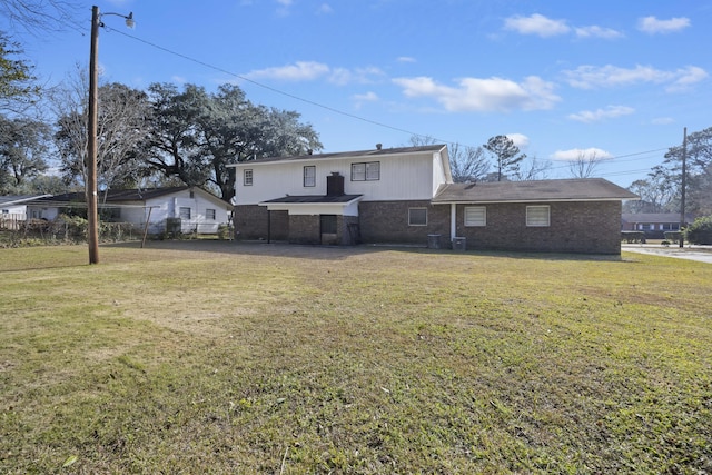 back of property featuring a lawn