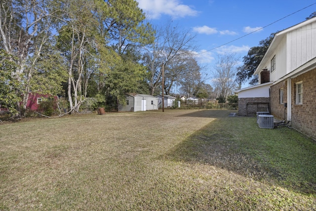 view of yard featuring cooling unit and a storage unit