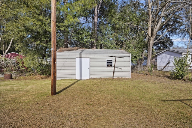 view of outdoor structure featuring a lawn