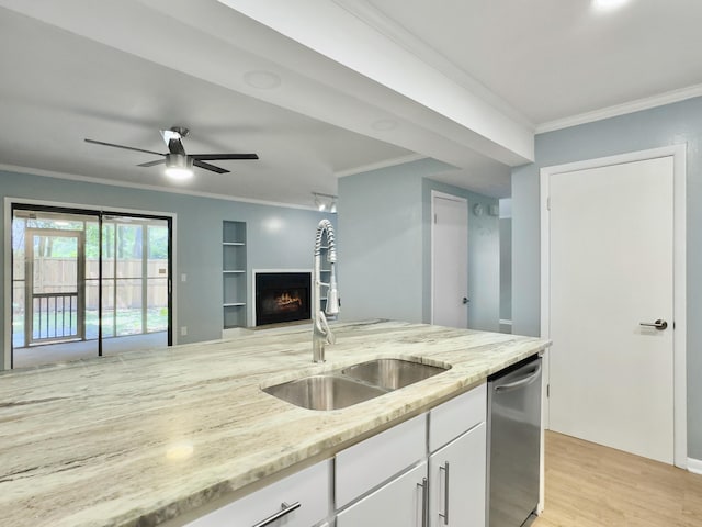 10 Stallion Ct, Charleston, SC 29407 - kitchen with stainless steel dishwasher, crown molding, a warm lit fireplace, light stone countertops, and white cabinetry