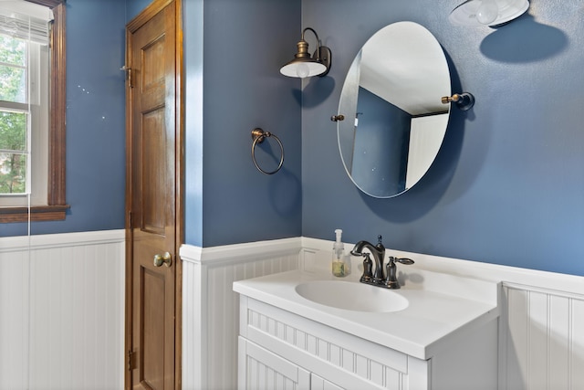 4097 NE Brown St, Orangeburg, SC 29118 - bathroom with a wainscoted wall, vanity, and a decorative wall