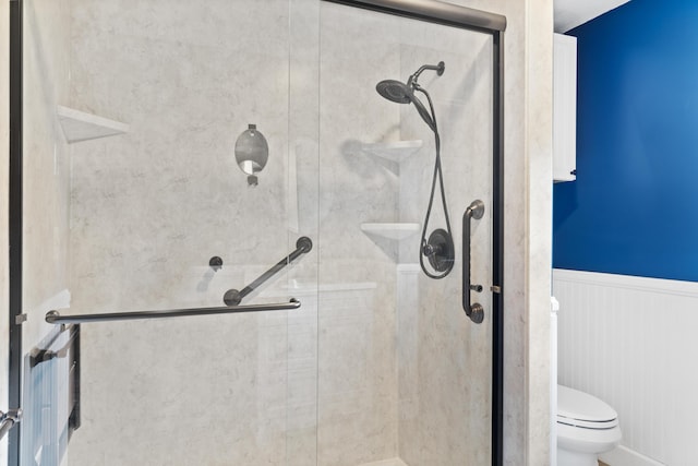 4097 NE Brown St, Orangeburg, SC 29118 - bathroom featuring a stall shower, wainscoting, and toilet