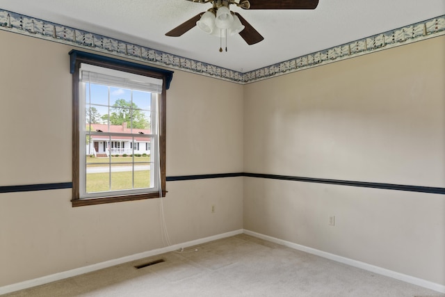 4097 NE Brown St, Orangeburg, SC 29118 - spare room featuring light carpet, baseboards, and a ceiling fan