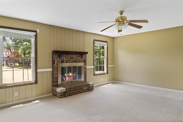 4097 NE Brown St, Orangeburg, SC 29118 - living area featuring healthy amount of natural light, ceiling fan, a fireplace, carpet flooring, and wood walls