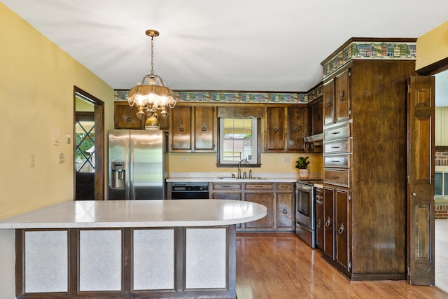 4097 NE Brown St, Orangeburg, SC 29118 - kitchen featuring stainless steel appliances, a sink, a chandelier, light countertops, and dark brown cabinets