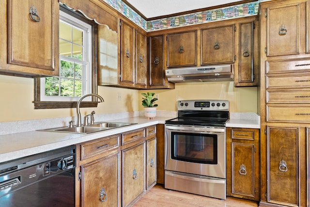 4097 NE Brown St, Orangeburg, SC 29118 - kitchen with under cabinet range hood, electric range, dishwasher, a sink, and light countertops
