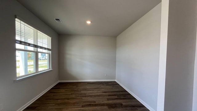 unfurnished room with dark hardwood / wood-style floors