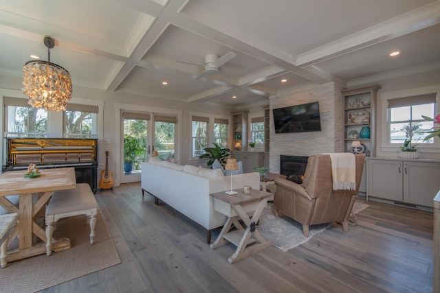 living room featuring plenty of natural light, coffered ceiling, and beamed ceiling