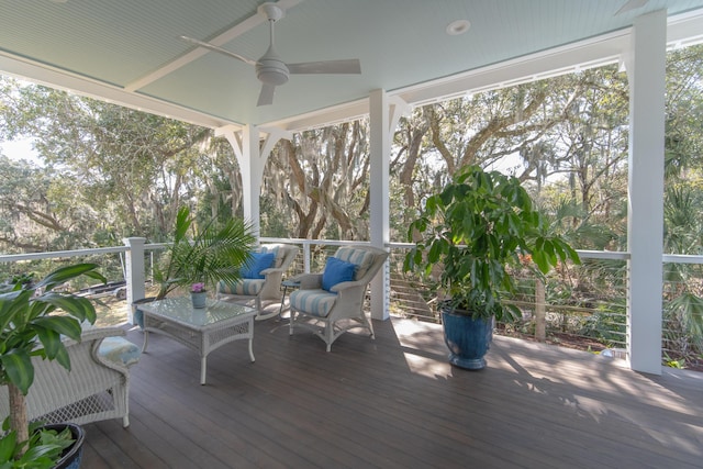 unfurnished sunroom with ceiling fan