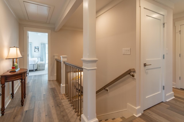 hall featuring attic access, an upstairs landing, and wood finished floors