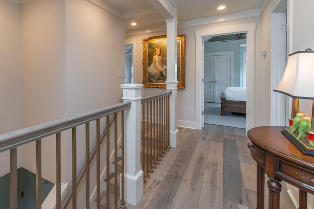 hall with recessed lighting, baseboards, an upstairs landing, and wood finished floors