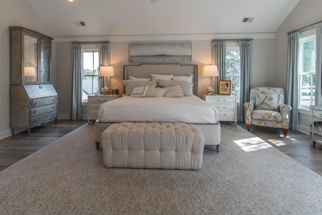 bedroom with lofted ceiling, multiple windows, and visible vents