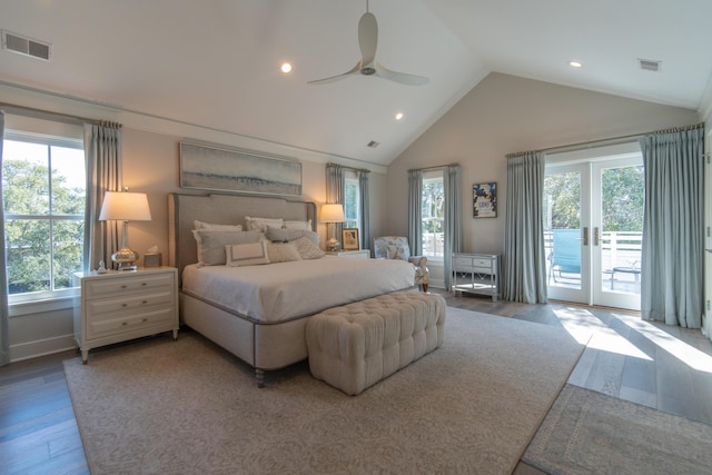 bedroom featuring vaulted ceiling, wood finished floors, visible vents, and access to exterior