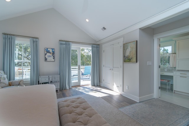 unfurnished bedroom featuring light wood-type flooring, access to outside, multiple windows, and visible vents