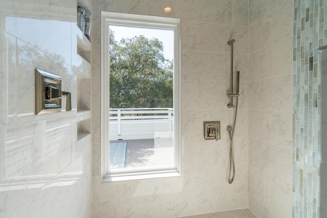 bathroom with tiled shower