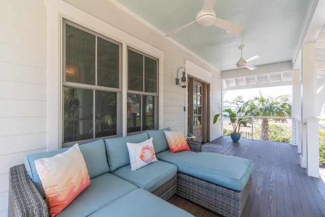 wooden deck featuring a porch and a ceiling fan